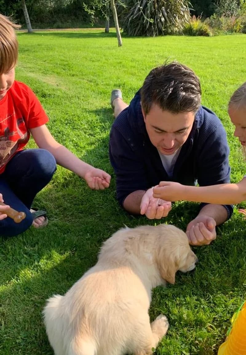 John with a golden retriever puppy